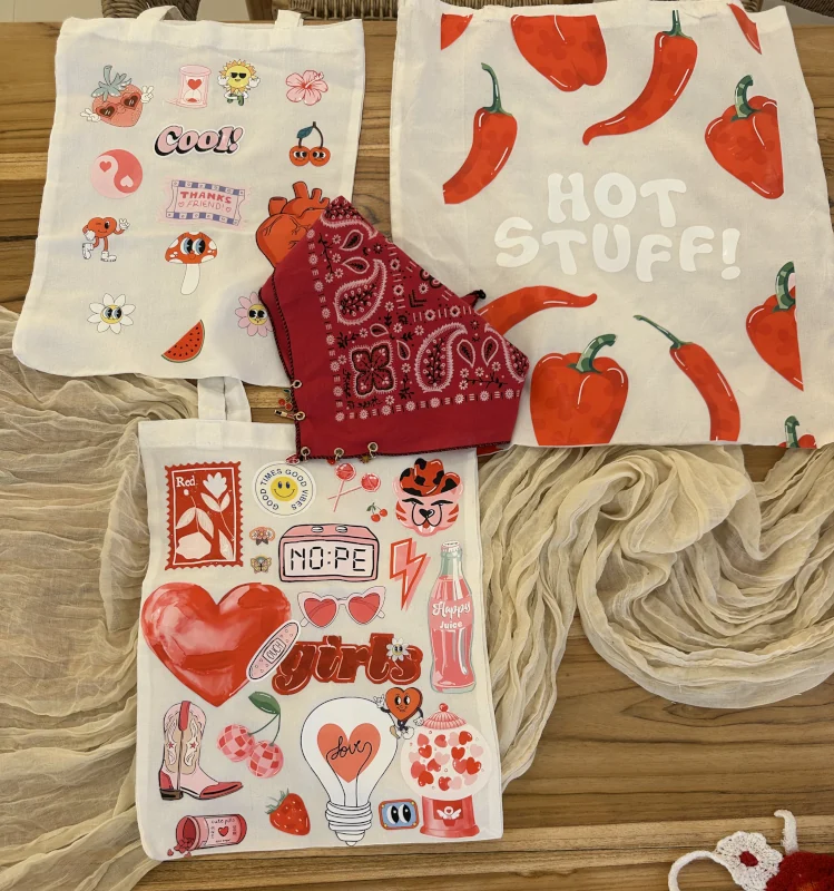 Three tote bags with custom sticker designs at Luma Numa in Bali