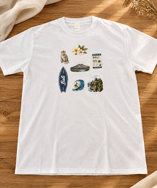 White t-shirt with Bali-inspired fabric stickers on a wooden table