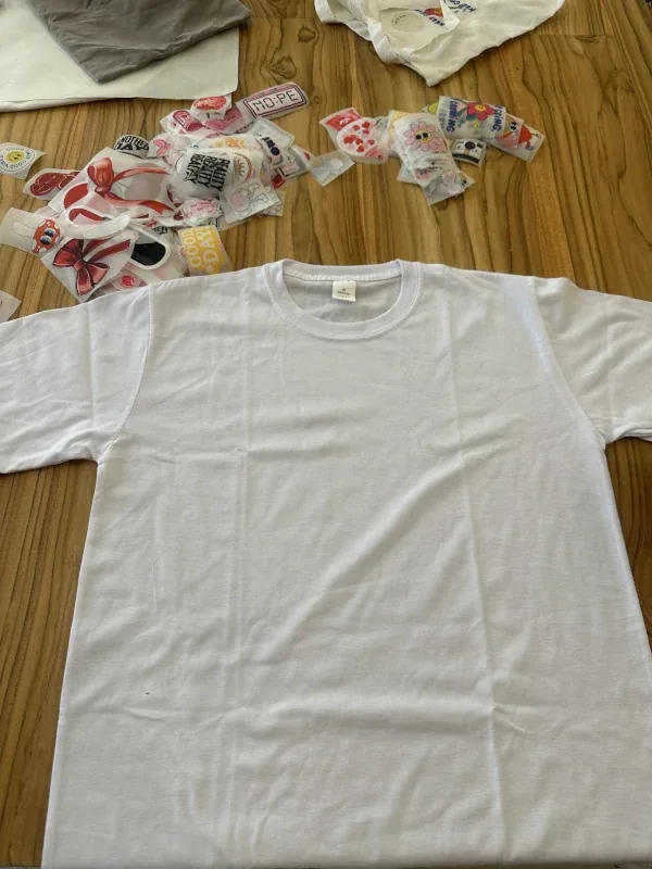 Blank white t-shirt surrounded by fabric sticker designs at the t-shirt workshop in Bali